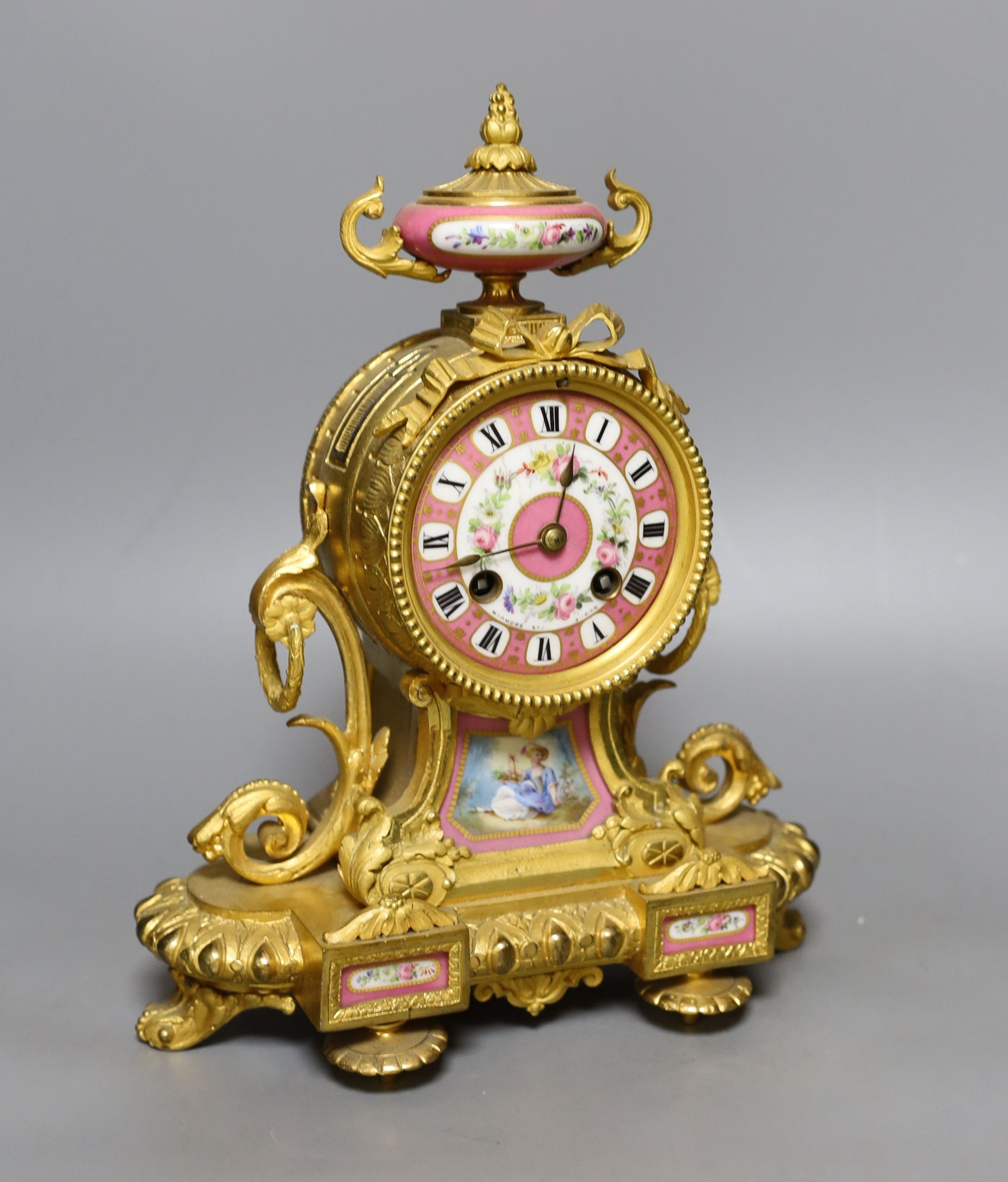A French ormolu mantel clock with Sevres style panels. Height 29cm